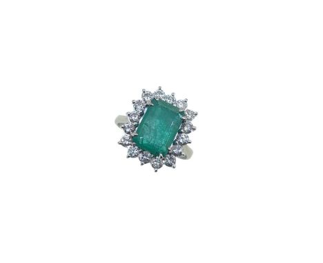 claw set central octagonal emerald, 10.9 x 7.7mm, estimated approximate weight 1.90ct, surrounded by a border of sixteen claw