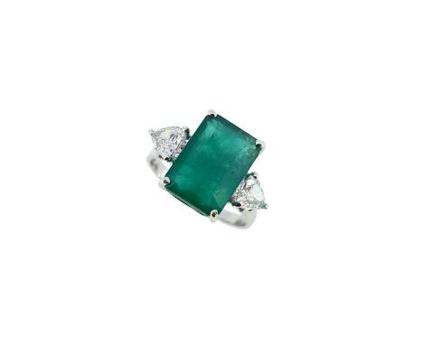 claw set octagonal emerald, 12.1 x 8.4mm, estimated approximate weight 3.50ct, flanked by two trilliant cut diamonds, approxi