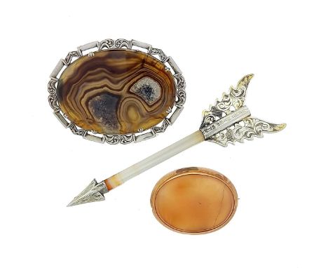first, an oval slice of brown/grey agate with a pierced border of alternate plain and carved panels, length 6.8cm, width 5cm,