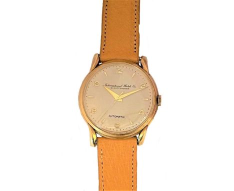circa 1954, the signed circular cream coloured dial, 32mm diameter, with gold coloured alternate batons and Arabic numerals, 