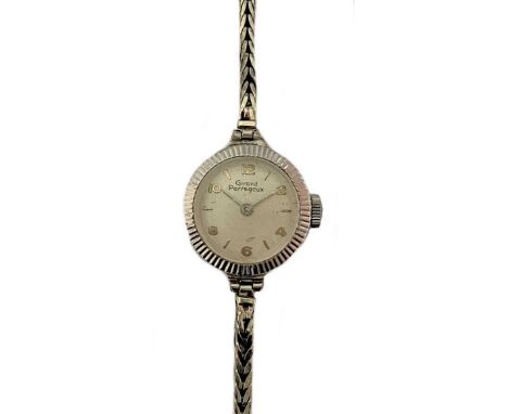 circa 1955, the signed circular cream coloured dial, 10mm diameter, with gold coloured alternate batons and Arabic numerals a