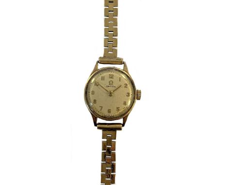 circa 1963, the signed circular cream coloured dial, 18mm diameter, with gold coloured Arabic numerals and hands and baton mi