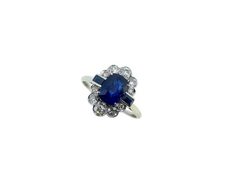 claw set cushion shaped sapphire 7.45 x 5.5mm, estimated approximate weight 1.75ct, flanked by channel set rectangular facete