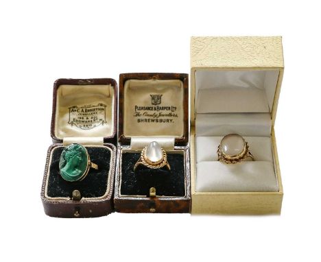 A moonstone ring, stamped '9CT', finger size L; a malachite cameo ring, unmarked, finger size P; and a 9 carat gold moonstone