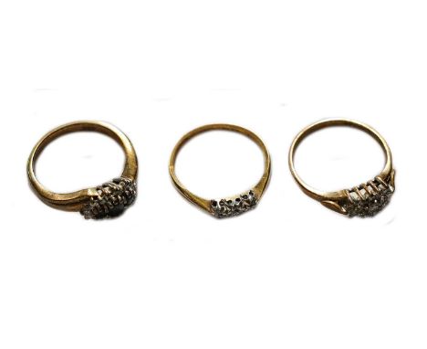 A diamond three stone ring, stamped '18CT' and 'PLAT', finger size J1/2; a 9 carat gold diamond cluster ring, finger size L; 