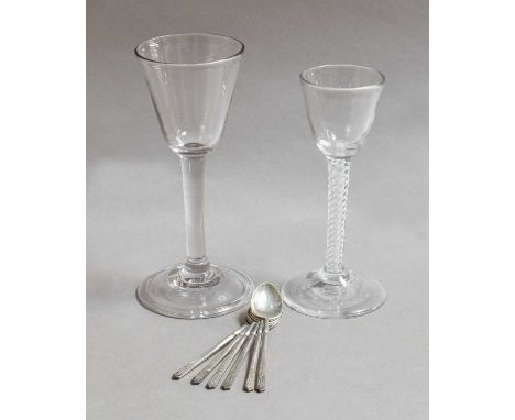 A wine glass with large funnel shaped bowl, plain stem and with folded foot; together with a similar wine glass with double s