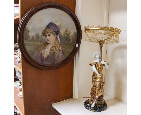 An Art Noveau style parcel gilt composite figural table lamp with beaded tassel shade; together with a pottery wall plaque wi