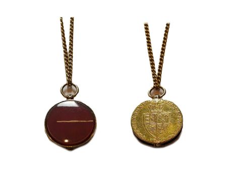 A locket formed of carnelian and a George III Spade Guinea dated 1790, on a trace link chain, chain length 61cmThe items are 