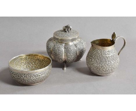 Three Various Indian Silver Items, including: a canister with pull-off cover, with elephant cast finial; a cream-jug with sna