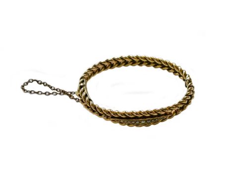 A split pearl hinged bangle, stamped '9CT', inner measurements 5.5cm by 4.8cmGross weight 13.2 grams.