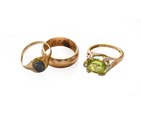 A 9 carat gold band ring, finger size O; a 9 carat gold hematite signet ring, finger size L1/2; and a 9 carat gold peridot ri