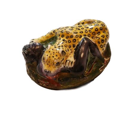 An 18th Century Staffordshire Enamel Snuff-Box, oval, the hinged cover enamelled in high relief with a scene of a leopard att