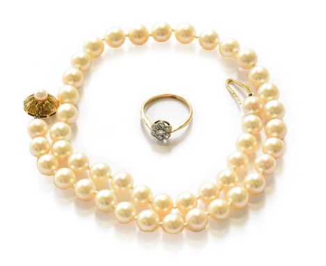 A diamond cluster ring, stamped '18CT', finger size L; and a cultured pearl necklace knotted to an 18 carat gold cultured pea