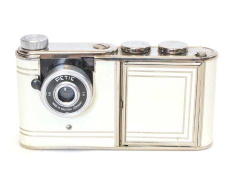 1950s West German "Petie" powder compact vanity miniature camera with white body.