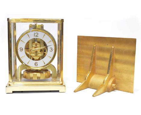 Jaeger-leCoultre Atmos clock and bracket with original box and instruction manual. The mantel clock with white and brass chap