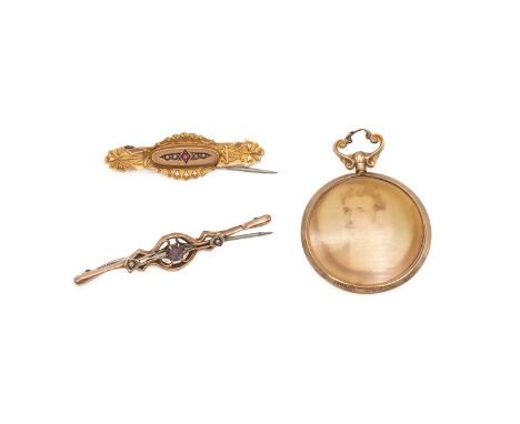 9ct gold rimmed pendant and two 9ct gold brooches, one set with a central amethyst and seed pearls, the other with a ruby and