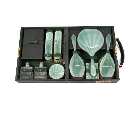 Art Deco green guilloche enamel vanity cased set, comprising four assorted brushes, two silver topped scent bottles, two silv