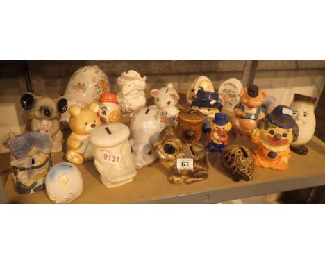 Shelf of approximately twenty mixed money boxes , mostly ceramic, including clown, frog etc