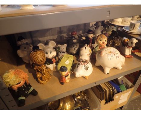 Shelf of approximately twenty five assorted money boxes, mostly ceramic including pigs, car, elephant etc