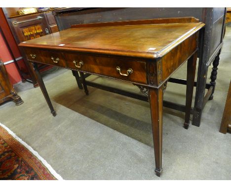 An Edward VII Chippendale Revival mahogany two drawer writing table 