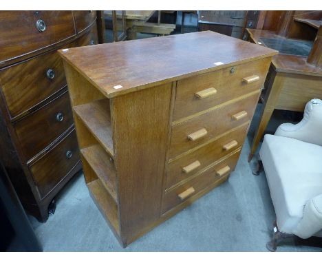 A light oak secretaire chest of drawers 