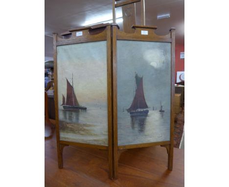 An Arts and Crafts oak folding two panel fire screen, painted with marine scenes 