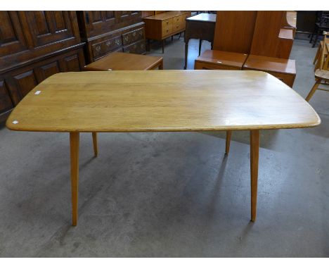 An Ercol Blonde elm and beech plank top dining table 