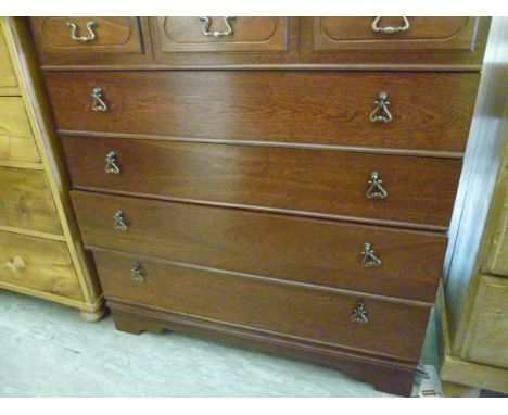 A modern mahogany finished five drawer dressing chest, raised on a bracket plinth  37''h  34''w          RAM