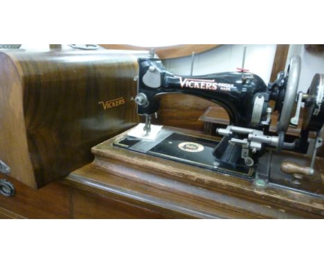 A Vickers manual sewing machine, in a walnut finished carrying case        CA