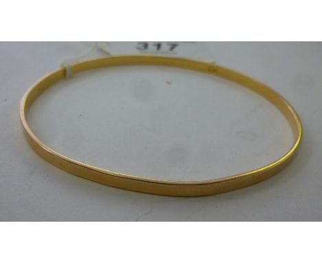 A yellow metal bangle of plain design       11