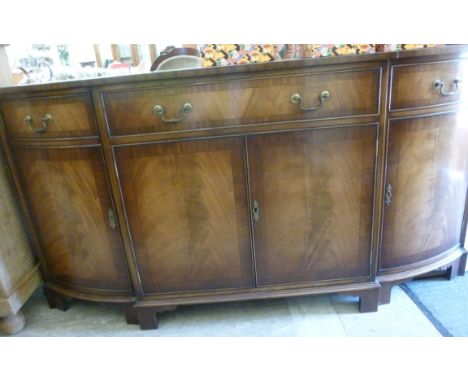 A modern Regency design mahogany finished breakfront sideboard, having a drawer, over twin doors, flanked by a pair of doors,
