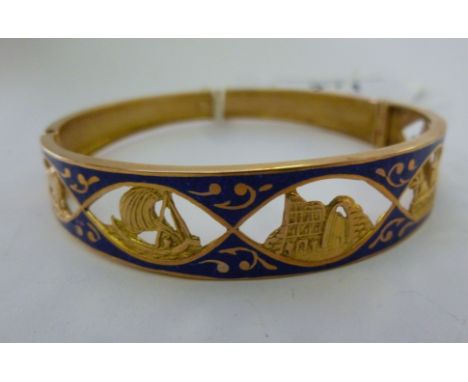 An Egyptian gold coloured metal bangle with blue enamelled decoration, pierced with landscape scenes       11