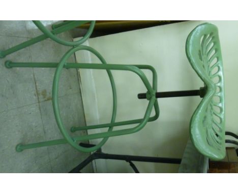 A modern green painted cast iron and steel height adjustable tractor style bar stool, raised on tubular legs        SR