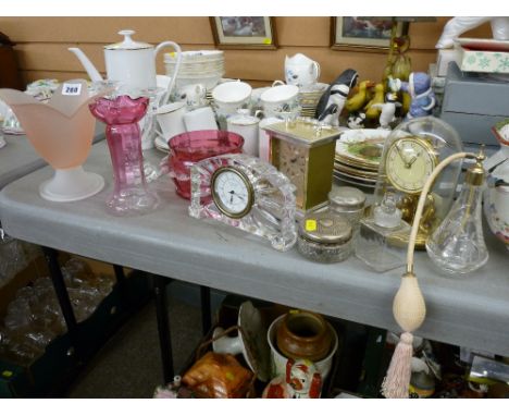 Two pieces of cranberry glass, Waterford crystal clock, a brass mantel clock by Koma with glass dome, various scent bottles e