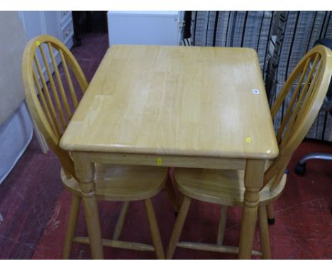 Modern light wood kitchen table and two spindleback chairs