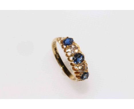 Ladies 18 carat gold five stone sapphire and diamond ring, the bright stones in Gypsy-style setting.