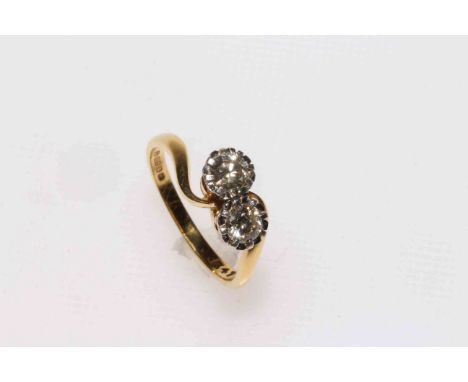 18 carat gold two stone diamond crossover ring, size N.