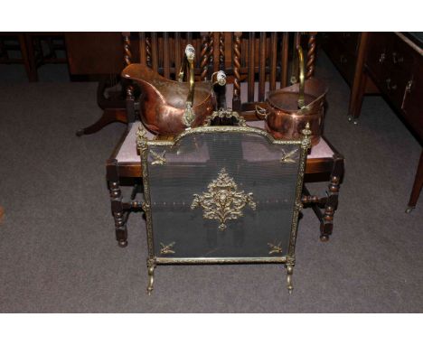 Ornate brass firescreen and two copper and brass coal scuttles.