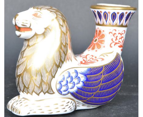 A contemporary Royal Crown Derby lion candlestick having polychrome decoration with gilt detailing. Gold stopper to the base.