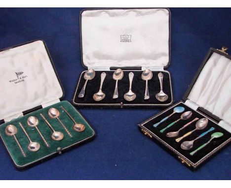 An early 20th century boxed set of silver and coloured enamel coffee spoons, together with a boxed set of silver coffee spoon