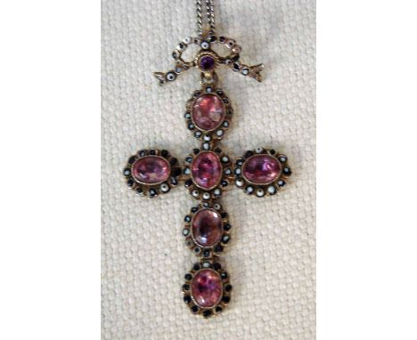 A 19th century continental silver pendant as a cross set with foil backed amethyst coloured stones, hinged suspension mount a