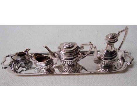 A miniature silver four piece tea service on a silver tray, Birmingham 1952, makers mark for DH & S together with a silver mu