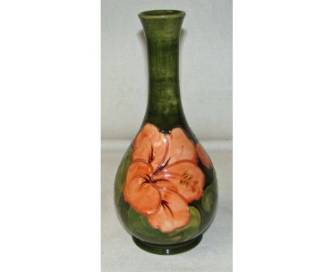 A Walter Moorcroft vase, circa mid 20th century, tubeline decorated in the Hibiscus pattern on a green ground, bears label an