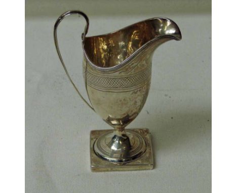 A George III silver helmet shaped cream jug, London 1796, on square base with engraved decoration, 16cm high, 4.2oz