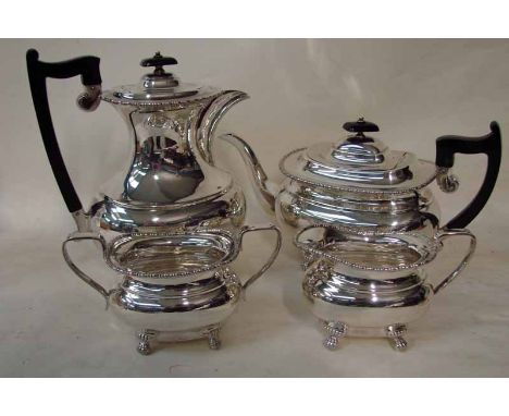 A mid to late 20th century silver four piece tea/coffee service of typical boat shape, gadrooned rim, each set on four paw fe