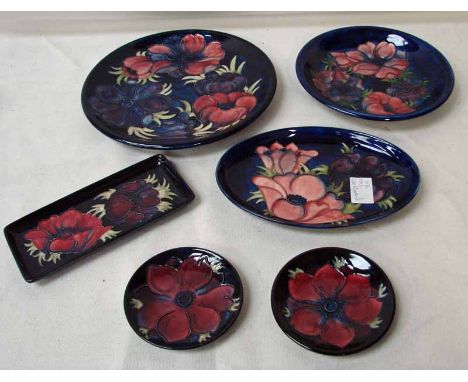 A group of six modern Moorcroft Anemone pattern comprising cake plate, shallow dish, pair of ashtrays, pin tray and oval dish