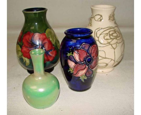 A group of four Moorcroft vases comprising an Anemone pattern vase, a Lily pattern vase, a small green lustre vase and an unf