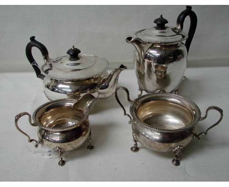 A silver four piece tea service, Sheffield 1920, of circular form with gadroon rim and shell feet, the teapot and coffee pot 