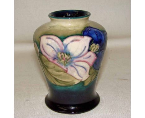 A William Moorcroft Clematis pattern vase, pre 1950, of baluster form on a blue/green wash ground, with painted blue initials