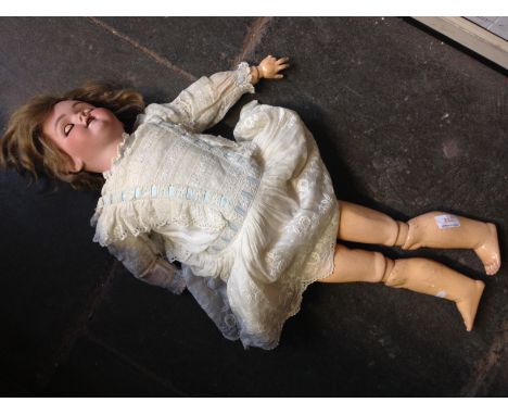 A HANDWERCK HALBIG BISQUE HEADED DOLL. L75CM J2CONDITION: MINOR CRACK TO THE BOTTOM OF THE NECK AT FRONT APPROX 1.5CM.